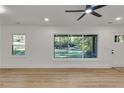 Bright living room with luxury vinyl plank flooring, fresh paint, and large windows showcasing the yard at 2358 Tilson Rd, Decatur, GA 30032