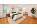 Serene main bedroom with wood floors, ensuite bathroom, and natural light from the bright windows at 2731 Tribble Mill Rd, Lawrenceville, GA 30045