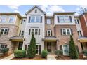 Well-manicured townhome featuring brick and siding accents, complemented by green landscaping and inviting entrance at 3058 Turman Cir, Decatur, GA 30033