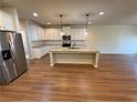 Bright kitchen features white cabinets, stainless steel appliances, granite countertops, and a spacious center island at 7843 Nolan Trl, Snellville, GA 30039