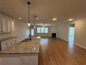 Open floor plan showcases the kitchen, living room with fireplace, and ample natural light from large windows at 7843 Nolan Trl, Snellville, GA 30039