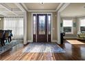 Inviting entryway with hardwood floors, coffered ceiling and a decorative front door with sidelights at 2481 Lake Erma Dr, Hampton, GA 30228