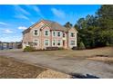 Stately two-story brick home with a long driveway and views of the lake at 2481 Lake Erma Dr, Hampton, GA 30228