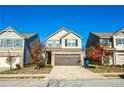 Charming two-story home with tan siding, brick accents, a two-car garage, and a well-maintained lawn at 264 Magnaview Dr, Mcdonough, GA 30253