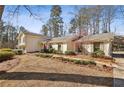 Brick ranch home with landscaped yard and mature trees at 7310 Hunters Branch Dr, Atlanta, GA 30328