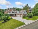 Two-story brick home with a large driveway and mature trees at 131 Gold Springs Ct, Canton, GA 30114