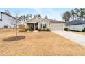 Well-manicured front lawn complements this single-story home, complete with a driveway and attached garage at 3695 Townley Ln, Cumming, GA 30040