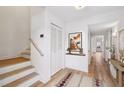 Bright entryway with wood stairs, coat closet, and decorative rug at 4620 Wieuca Ne Rd # 62, Atlanta, GA 30342