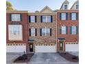 Three townhouses with brick exteriors, two-car garages, and shutters at 474 Williamson Se St, Marietta, GA 30060