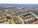 Aerial view of a residential neighborhood with houses and a lake in the background at 4345 Settlers Grove Rd, Cumming, GA 30028
