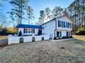 Two-story house with white siding, black shutters, and a landscaped yard at 110 Randomwood Way, Alpharetta, GA 30022