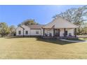 White farmhouse with a front porch and American flag at 2418 Claude Brewer Road Rd, Loganville, GA 30052