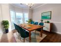 Bright dining room featuring a wood table, teal chairs, and a large window at 335 Wilma Sw Ct, Atlanta, GA 30331