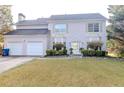 Two-story house with a white brick facade, double attached garage, and a neatly landscaped lawn at 335 Wilma Sw Ct, Atlanta, GA 30331