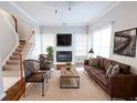 Spacious living room with a fireplace, leather sofas, and a large TV at 335 Wilma Sw Ct, Atlanta, GA 30331