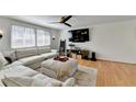 Bright living room with hardwood floors, a large sectional sofa, and modern decor at 1230 Worthington Hills Dr, Roswell, GA 30076