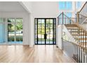 Bright foyer with hardwood floors, staircase with metal railings, and large windows for natural light at 3661 Clubwood Trl, Marietta, GA 30068