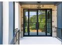 Front door with black metal grid, sidelights, transom window, stone surround, and painted porch at 3661 Clubwood Trl, Marietta, GA 30068