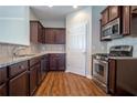 Kitchen with stainless steel appliances, dark cabinets, and tile backsplash at 4805 West Village Way # 3207, Smyrna, GA 30080