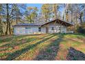Cozy, single-story home nestled among tall trees with a covered porch that offers outdoor living space at 550 S Rays Rd, Stone Mountain, GA 30083