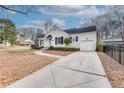 Street view of a charming home with a long driveway and manicured front yard landscaping at 332 Shadowmoor Dr, Decatur, GA 30030