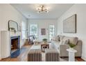 Cozy living room featuring a fireplace, hardwood floors, and plenty of natural light creating a welcoming space at 332 Shadowmoor Dr, Decatur, GA 30030