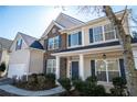 Charming two-story home with stone facade, blue shutters, and a welcoming front porch at 7972 Applemist Dr, Fairburn, GA 30213