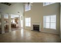 Bright living room with high ceilings, large windows, fireplace, and tile floors at 7972 Applemist Dr, Fairburn, GA 30213