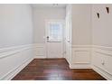 Bright foyer featuring beautiful wood-look floors, wainscoting, and a view of the front door at 1693 Fair Oak Way, Mableton, GA 30126