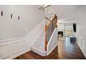 Elegant staircase with wood railing and carpeted steps, leading to the upper level at 1693 Fair Oak Way, Mableton, GA 30126