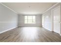 Bright living room featuring large windows and wood-look floors at 225 Bentley Pl, Tucker, GA 30084