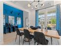 Modern dining room with a blue accent wall and wood table at 2416 Cadenza Cir, Dacula, GA 30019