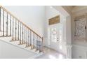 Bright entryway with staircase and decorative accents at 4596 Birch Way, Loganville, GA 30052