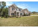 Two-story brick house with landscaped yard at 220 Seth Ter, Mcdonough, GA 30252