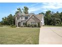 Two-story home with large yard and concrete driveway at 220 Seth Ter, Mcdonough, GA 30252