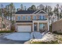 Two-story brick home with a white garage door and landscaping at 628 Leafy Branch Way, Mcdonough, GA 30253