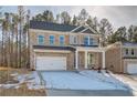 Two-story brick home with a white garage door and landscaping at 628 Leafy Branch Way, Mcdonough, GA 30253