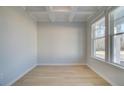 Sunlit office space featuring a coffered ceiling, large windows, and light wood flooring at 628 Leafy Branch Way, Mcdonough, GA 30253