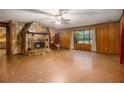 Living room featuring a stone fireplace and wood walls at 170 Pebble Path, Douglasville, GA 30134