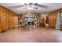 Spacious living room with a stone fireplace and wood paneling at 170 Pebble Path, Douglasville, GA 30134