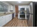 Updated kitchen with stainless steel appliances, granite countertops, and white cabinetry at 2980 Laguna Dr, Decatur, GA 30032