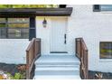 Inviting front entrance with new door and wooden handrail at 3594 Hillsborough Ln, Decatur, GA 30032