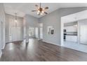 Spacious living room featuring hardwood floors, high ceilings, modern lighting, and open layout to the kitchen at 287 Jenna Ln, Dallas, GA 30157