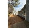 Backyard featuring a brick retaining wall and tidy landscaping at 4815 Diggers Way, Sugar Hill, GA 30518