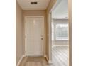 Inviting entryway with light-wood floors and views to the bright bay window in the living area at 4815 Diggers Way, Sugar Hill, GA 30518