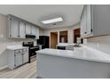 Open kitchen featuring gray cabinets, white countertops, and stainless steel appliances at 4815 Diggers Way, Sugar Hill, GA 30518