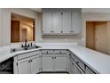 Bright kitchen showcasing a stainless steel sink, white countertops, and view of the living space at 4815 Diggers Way, Sugar Hill, GA 30518