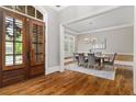 Spacious foyer featuring hardwood floors and an elegant dining room with a chandelier at 4508 Oakside Pt, Marietta, GA 30067