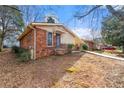 Side view of brick ranch home showcasing landscaping at 108 Woodhaven Dr, Stockbridge, GA 30281