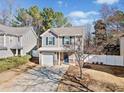 Two-story house with gray siding, white garage door, and a landscaped yard at 151 Nacoochee Way, Canton, GA 30114